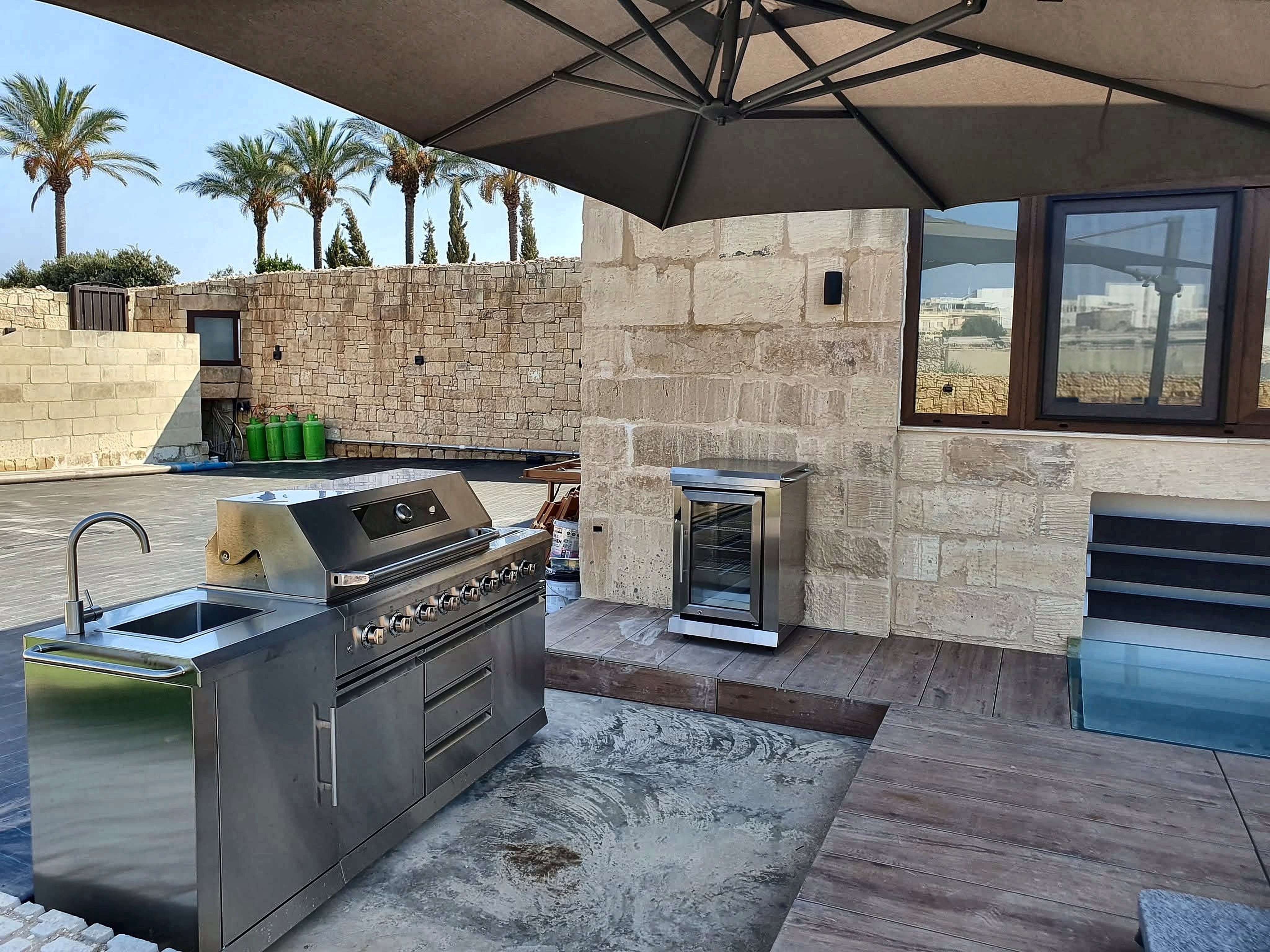 Outdoor stainless steel gourmet kitchen, BBQ grill and bar
